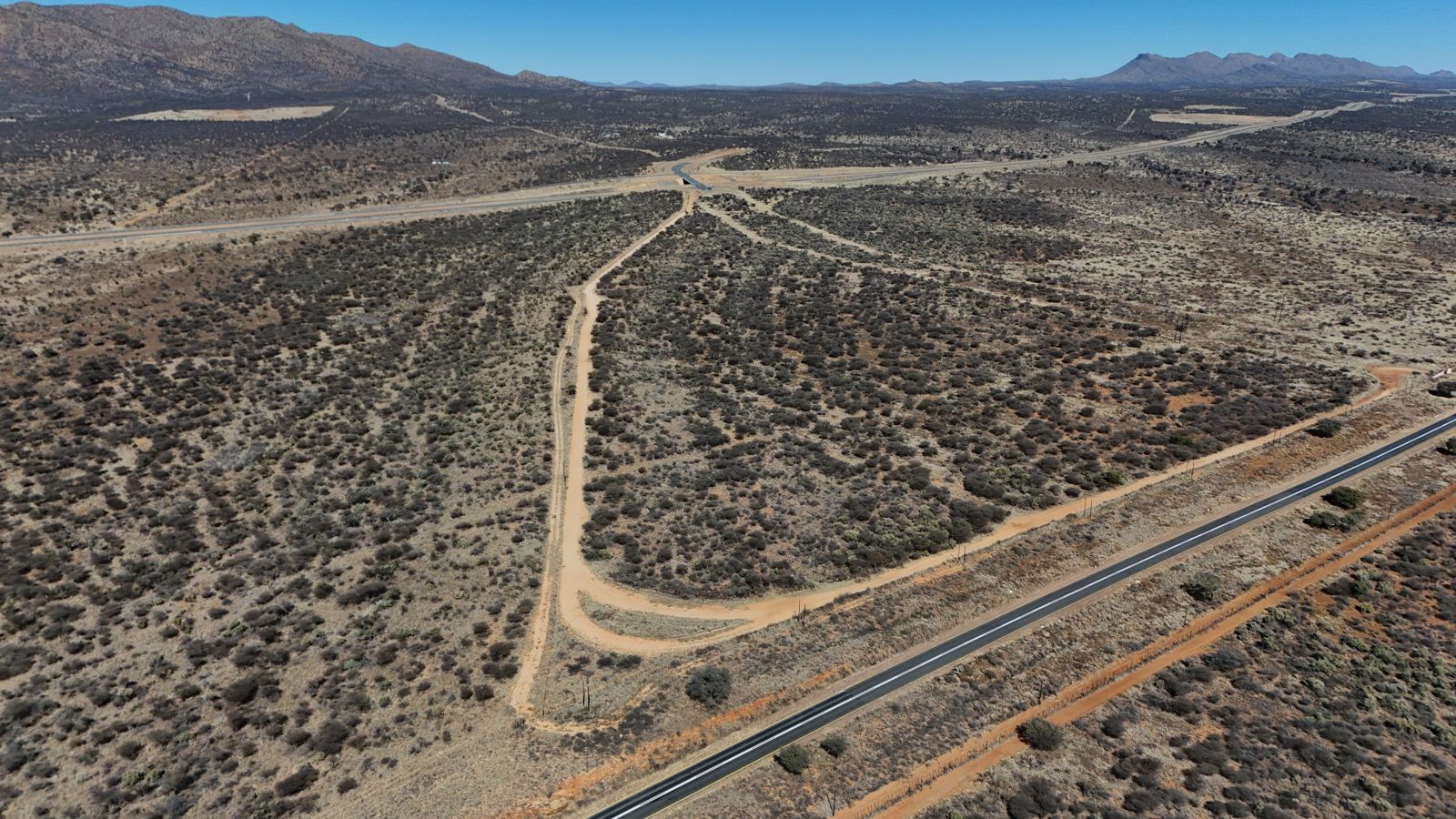 Drone photograph — access roads meeting the A1 at the Amushelelo site
